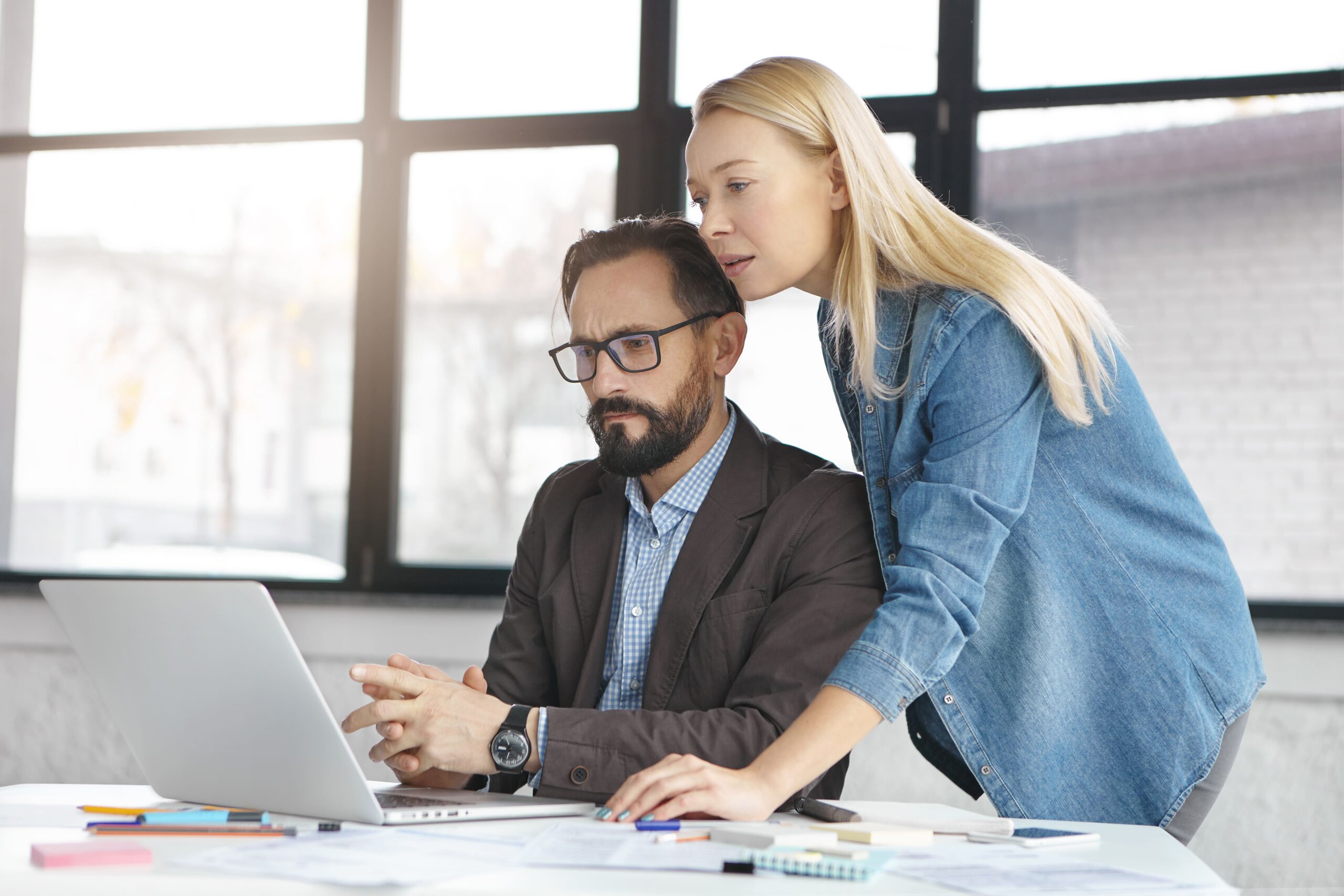 happy-blonde-female-manager-has-conversation-with-male-colleague